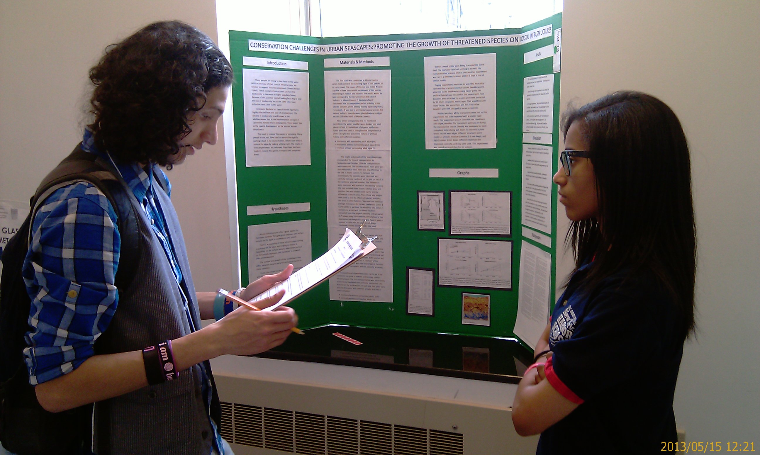 Tahirah relating her project on Econcrete to 12th grader Marc