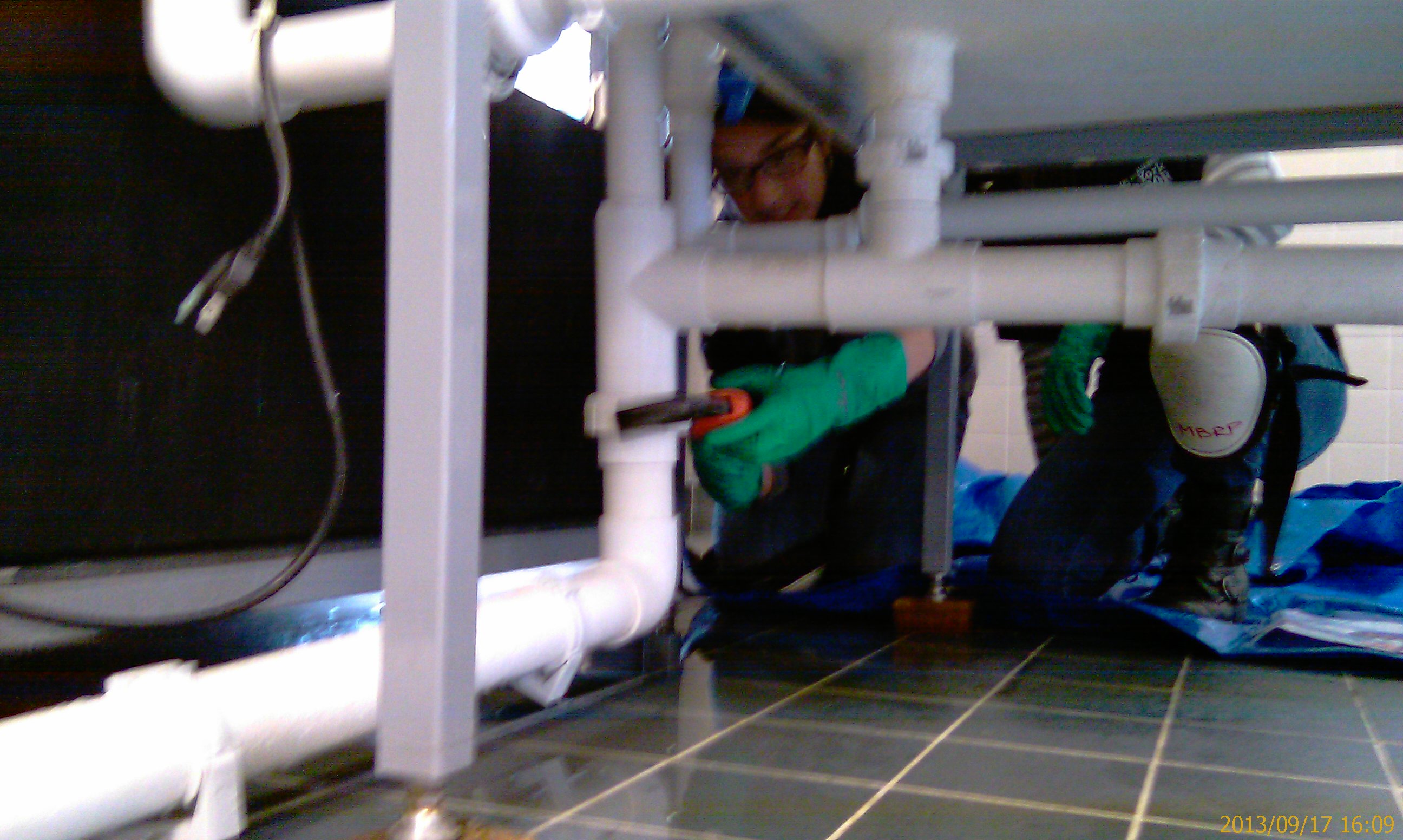 Jade and Tahirah remove the plumbing from our recirculating system to prepare it for its move to the greenhouse.
