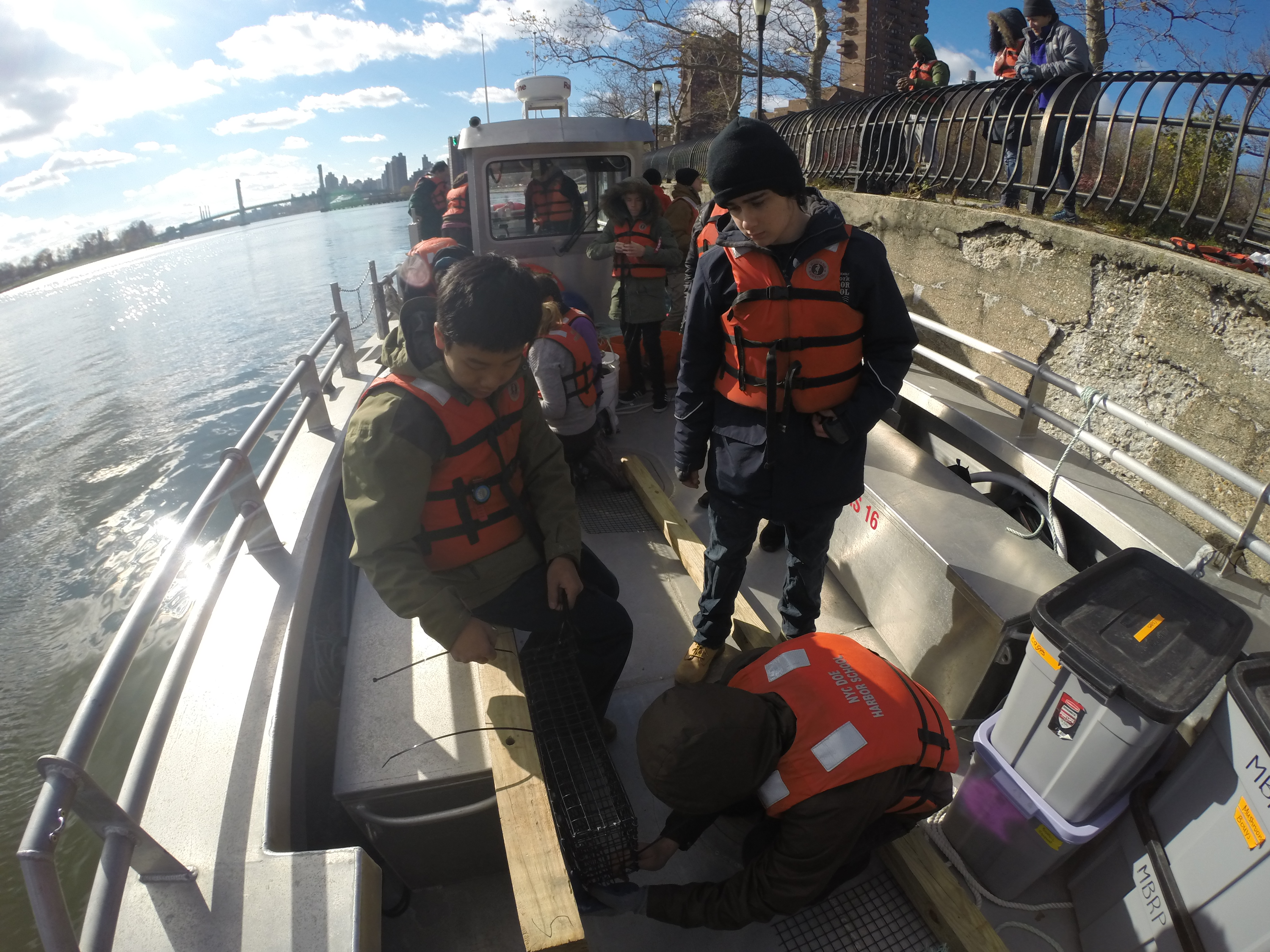 MBRP scholars deploying an experiment on the Harlem River for the Non-Profit group CIVITAS Citizens.